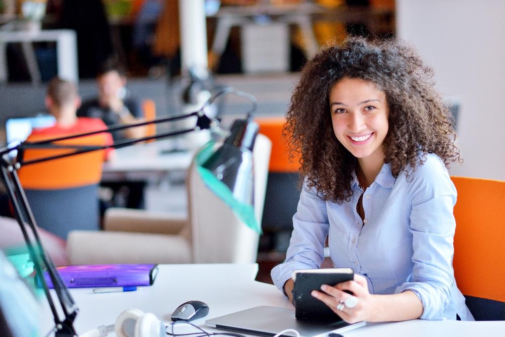woman working at desk with lamp | dental crowns 11201