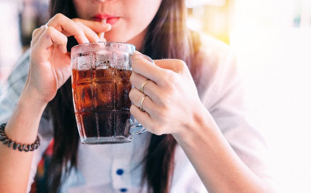 woman sipping soda | dental fillings brooklyn