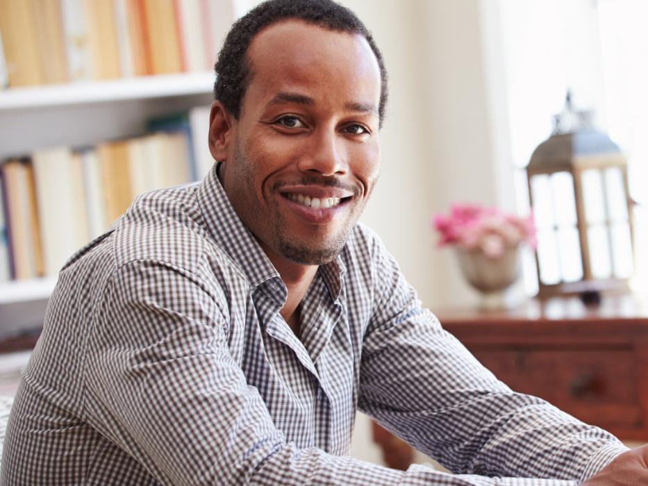 man in checkered shirt smiling | dental crowns 11201