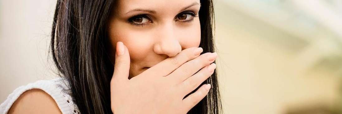 woman covering mouth with hand | dumbo dental care