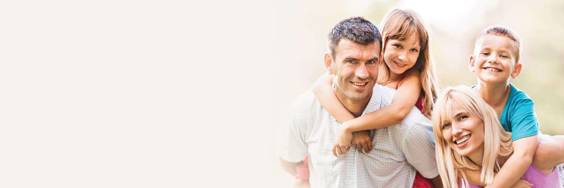 family of four hugging | pediatric dentistry dumbo