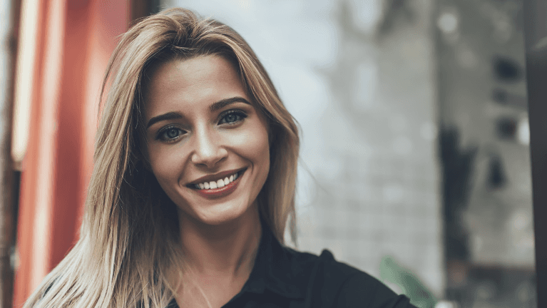 woman in black shirt smiling | cosmetic dentistry brooklyn ny