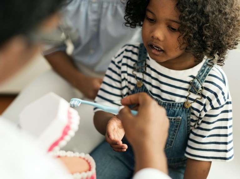 child looking at dentist | pediatric dentist dumbo