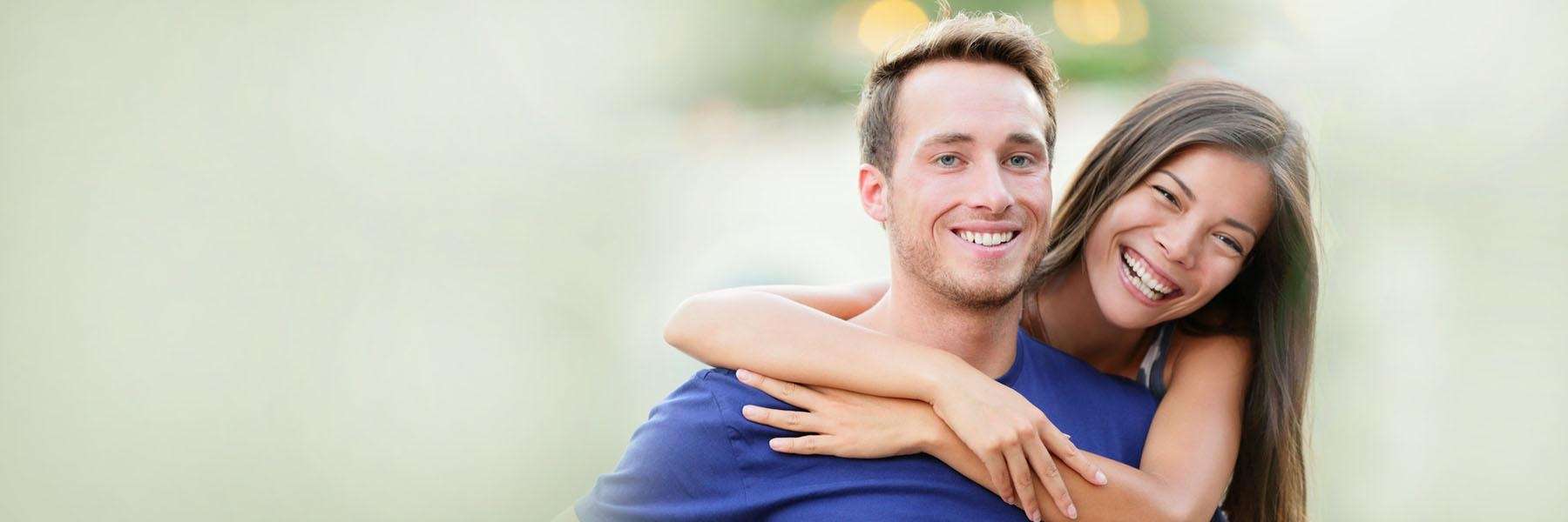 young couple hugging | dental crowns 11201