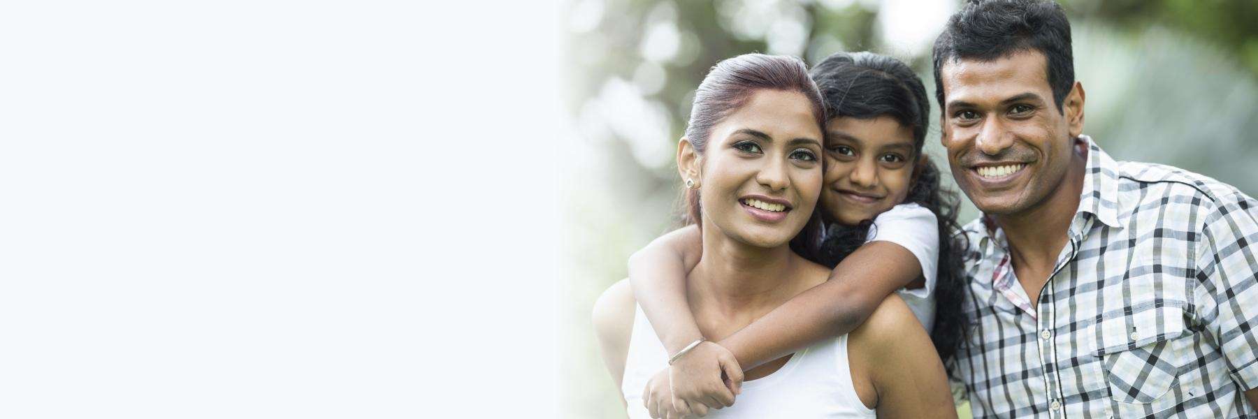 family of three hugging | family dentist dumbo