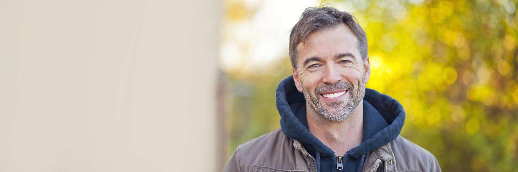man in jacket smiling | dentist near me