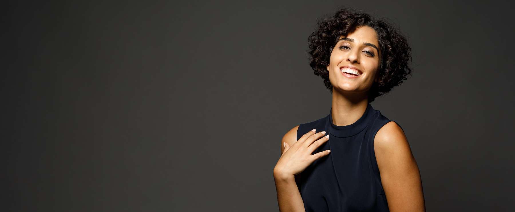 woman in black shirt smiling | teeth cleaning dumbo heights